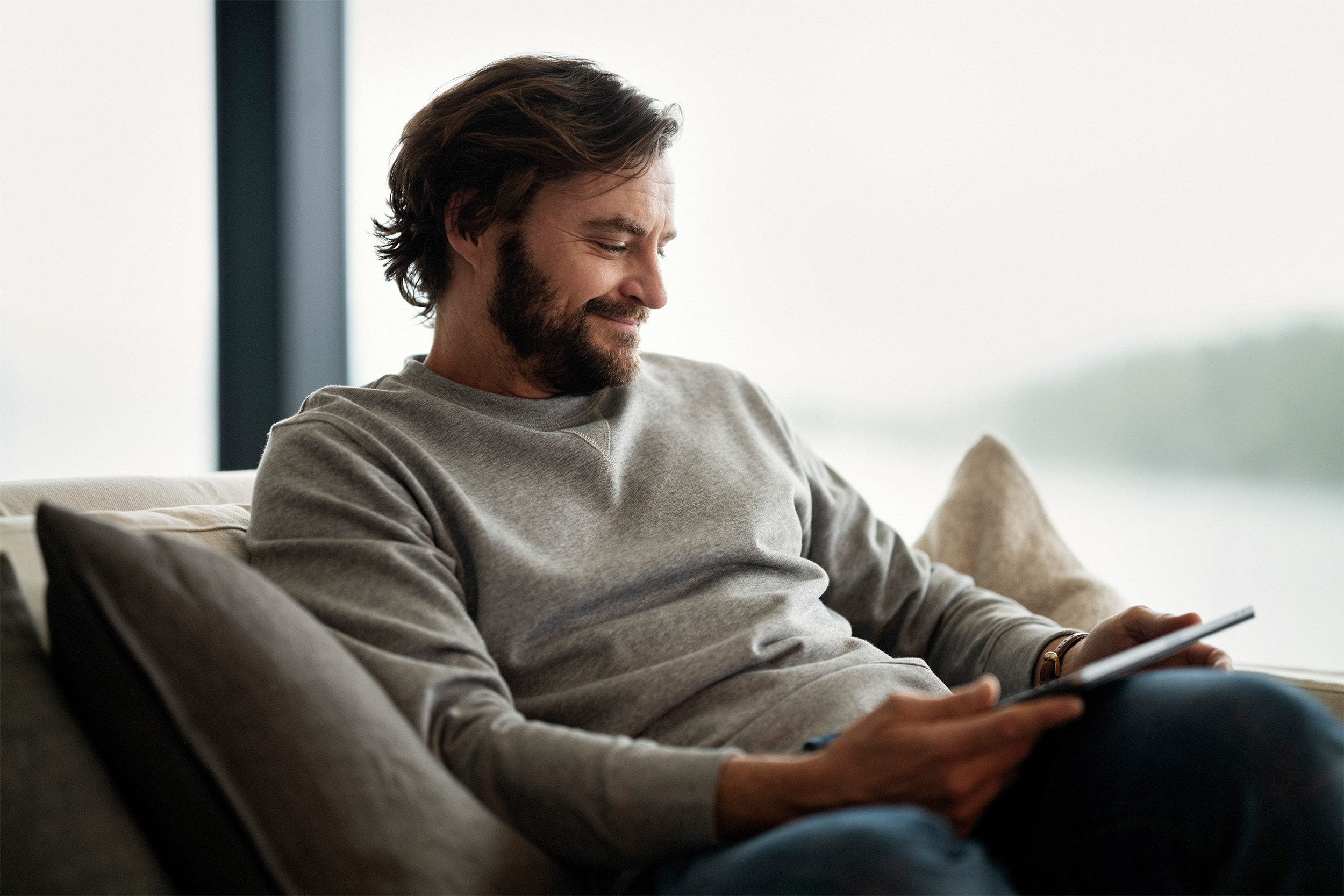 Man sofa tablet