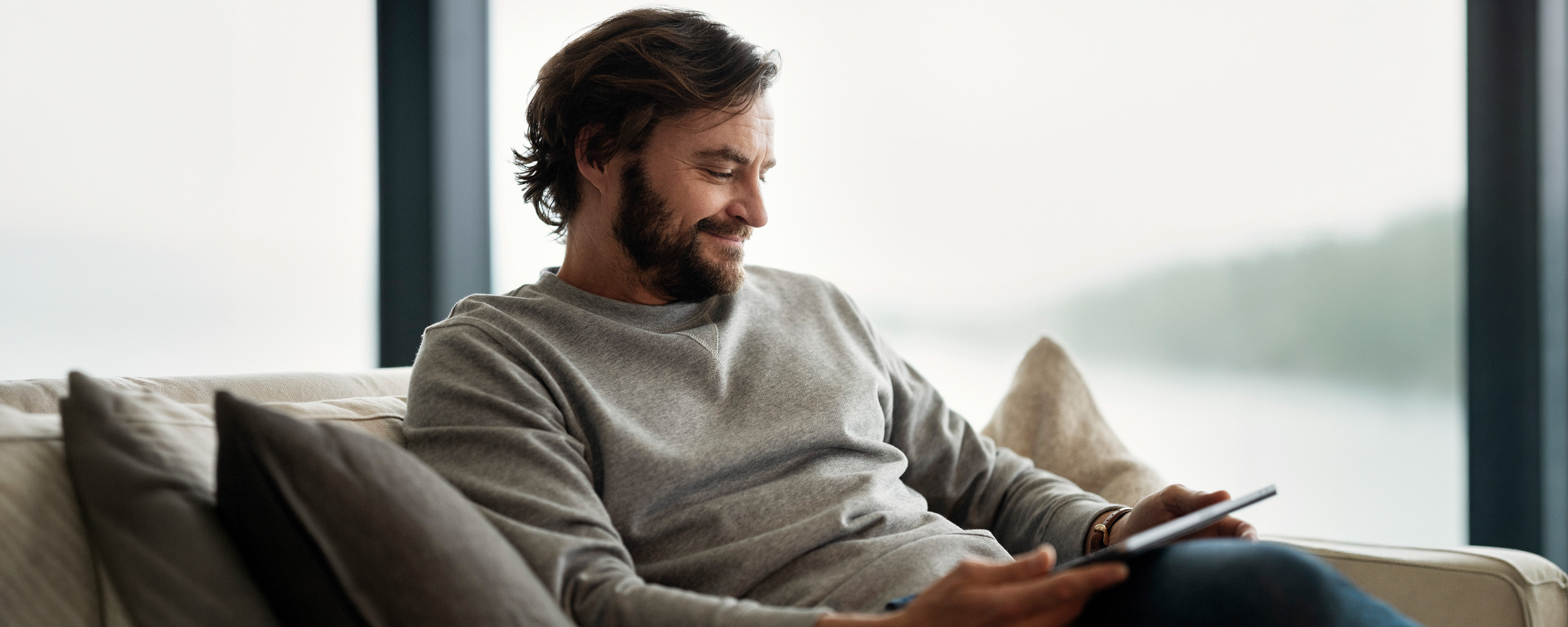 Man sofa tablet featured